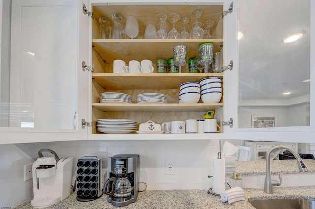 details featuring sink and light stone countertops