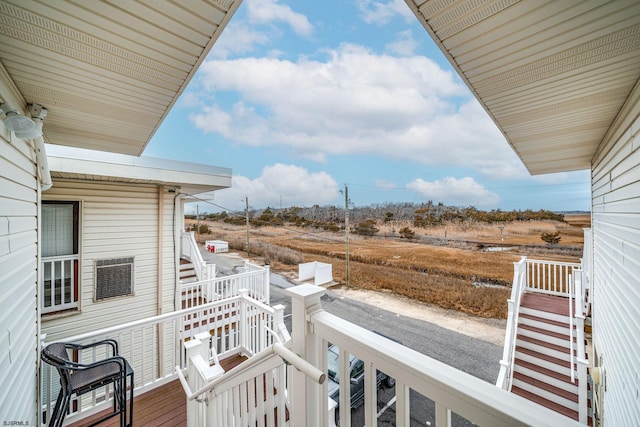 wooden balcony featuring a rural view and a deck