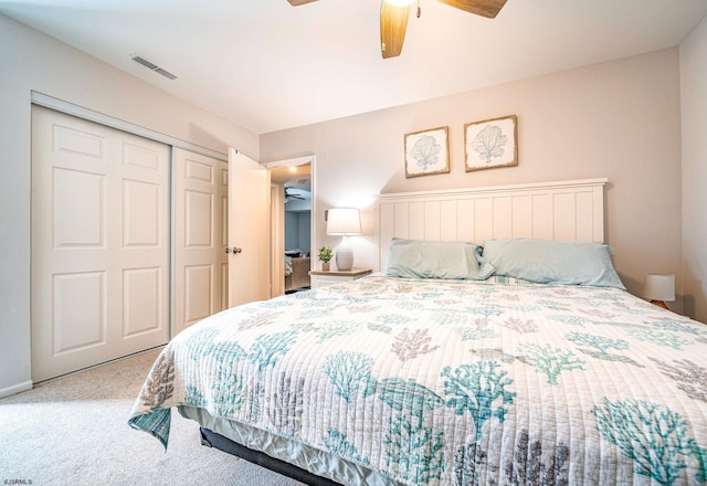 carpeted bedroom with ceiling fan and a closet