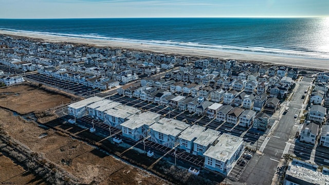 birds eye view of property featuring a beach view and a water view