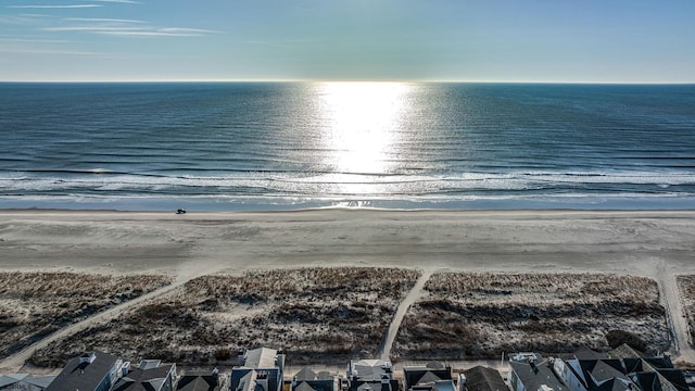 bird's eye view featuring a view of the beach and a water view