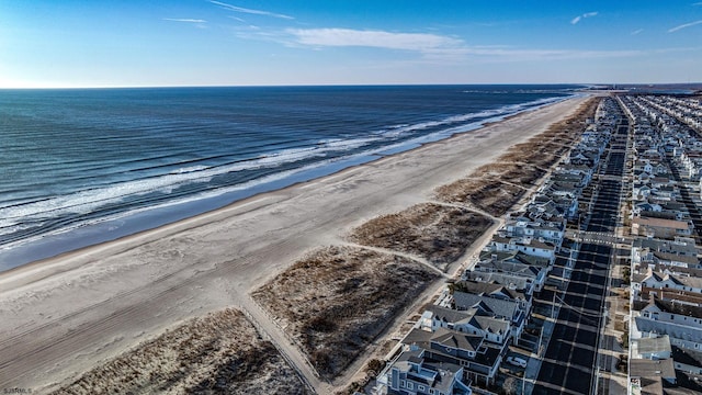 birds eye view of property with a view of the beach and a water view