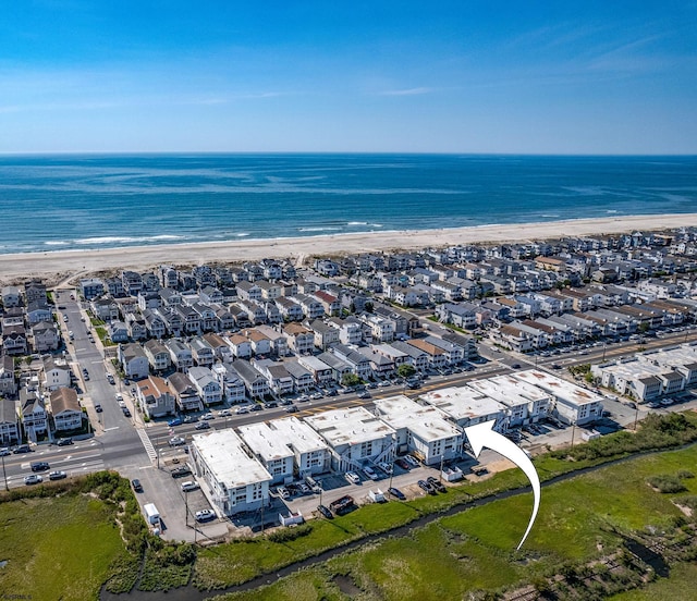 birds eye view of property with a view of the beach and a water view