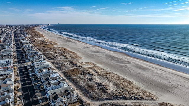 drone / aerial view with a water view and a view of the beach