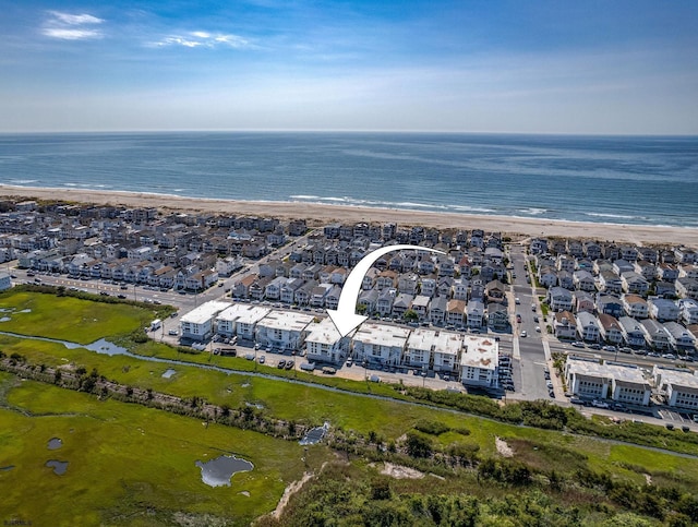 aerial view featuring a view of the beach and a water view