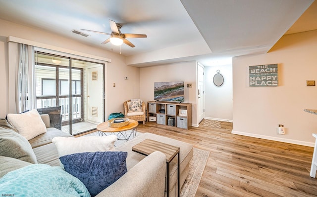 living room featuring ceiling fan and light hardwood / wood-style flooring