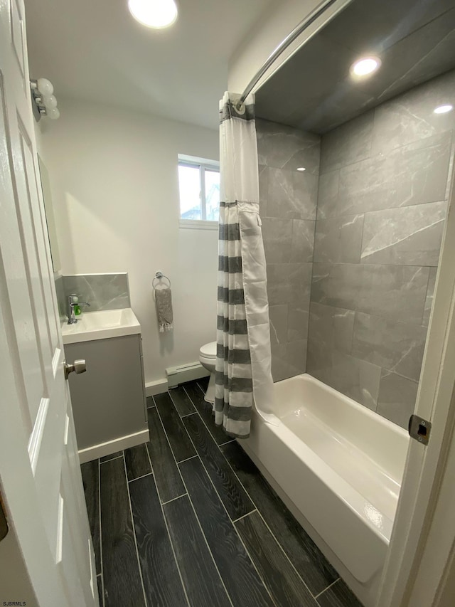 full bathroom with a baseboard radiator, vanity, toilet, and shower / tub combo