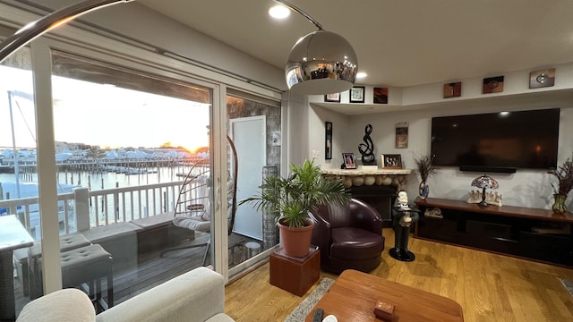 living room featuring a water view and hardwood / wood-style flooring