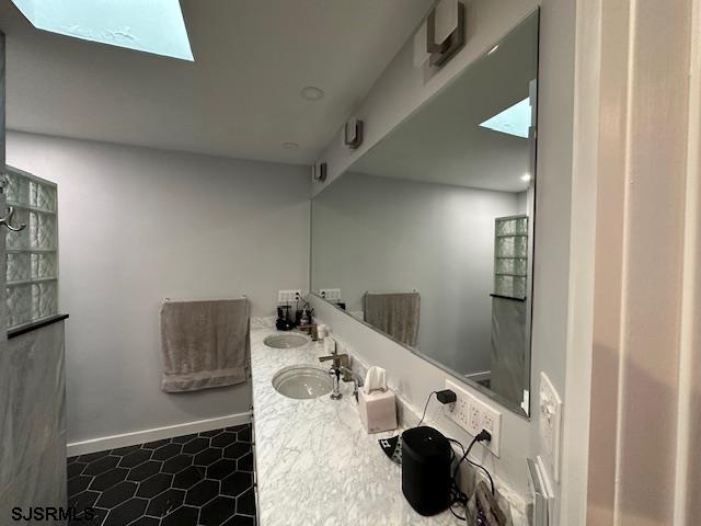 bathroom featuring vanity and a skylight