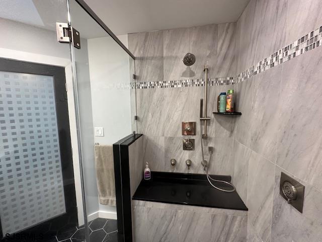 bathroom featuring tile patterned flooring and plus walk in shower