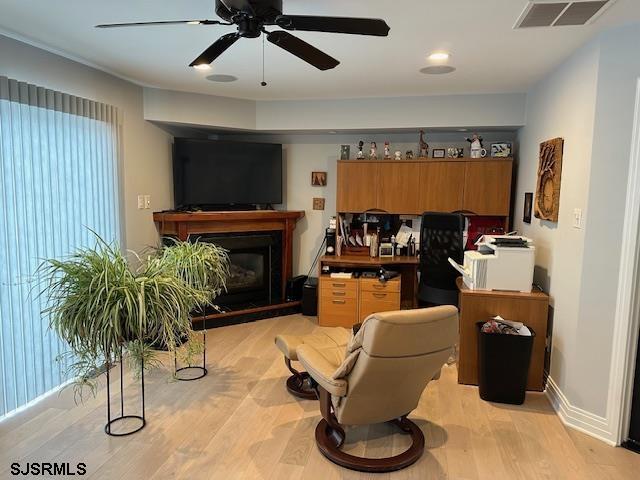 interior space featuring ceiling fan, plenty of natural light, and light wood-type flooring