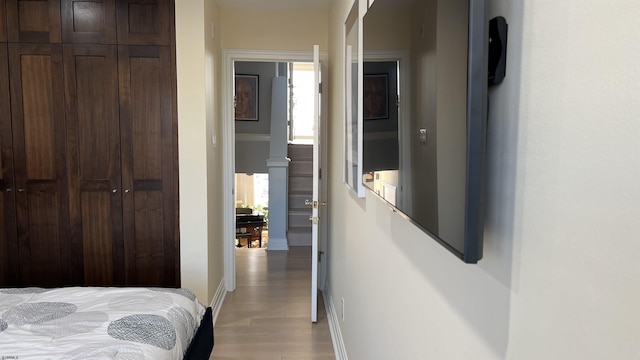 bedroom featuring light hardwood / wood-style floors and a closet