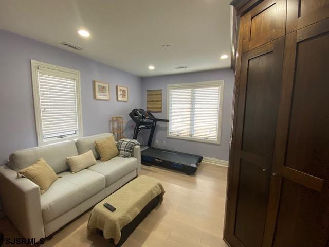 workout room with light hardwood / wood-style flooring