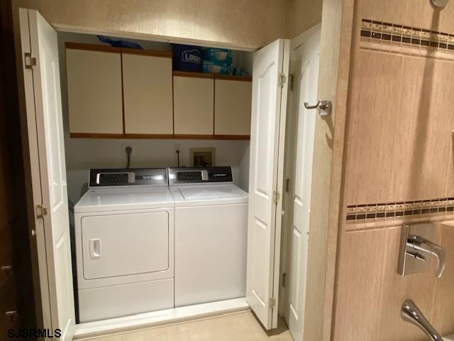 laundry room with cabinets and washer and dryer