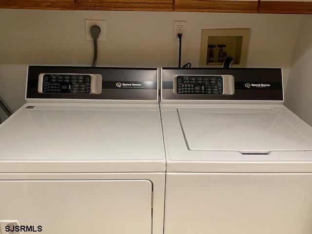 clothes washing area with separate washer and dryer