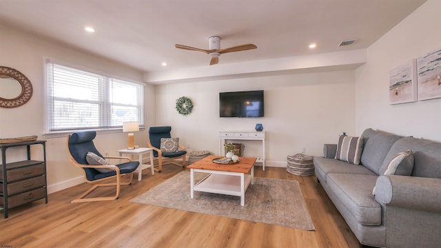 living room with wood-type flooring and ceiling fan