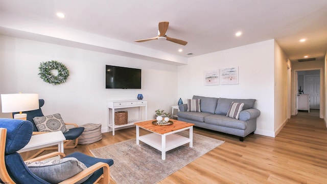 living room with ceiling fan and light hardwood / wood-style floors