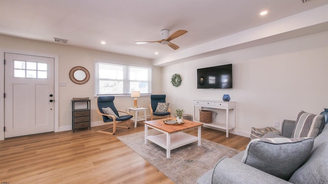 living room featuring ceiling fan and light hardwood / wood-style floors