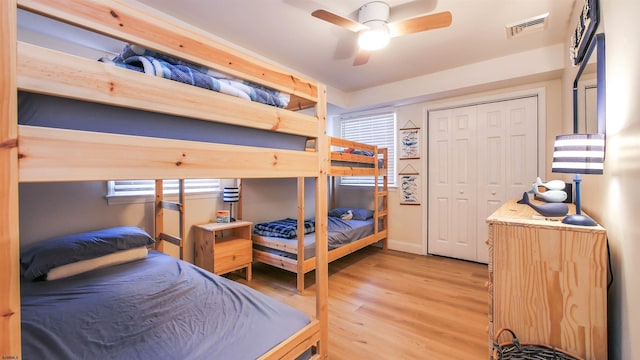 bedroom featuring ceiling fan, a closet, and light hardwood / wood-style flooring