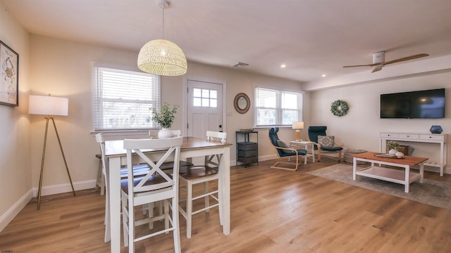 dining room with hardwood / wood-style floors and ceiling fan