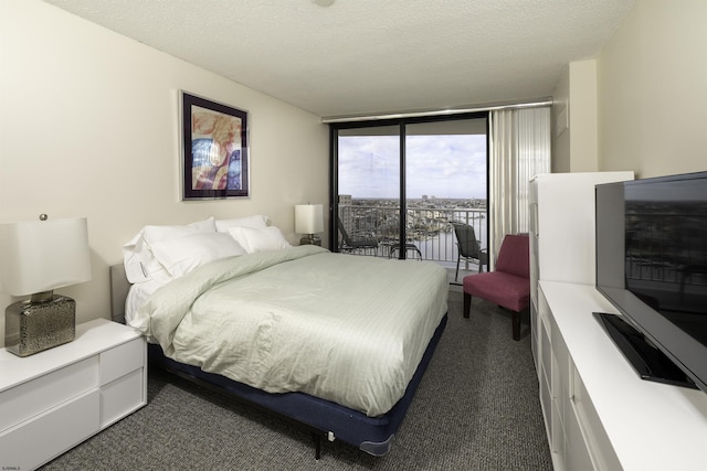 carpeted bedroom featuring access to outside, floor to ceiling windows, and a textured ceiling