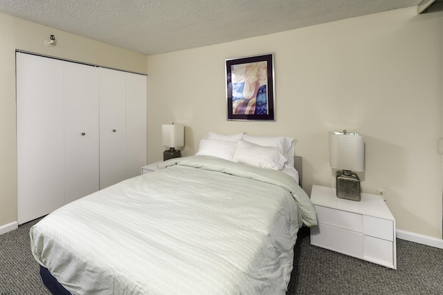 carpeted bedroom featuring a closet and a textured ceiling