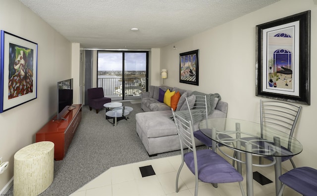 living room featuring floor to ceiling windows and a textured ceiling