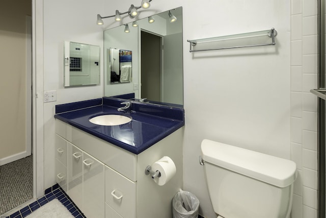 bathroom featuring vanity, toilet, and tile patterned flooring