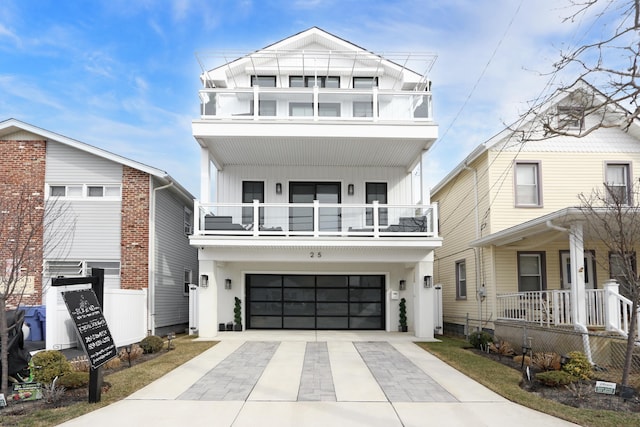 view of front of property featuring a garage and a balcony