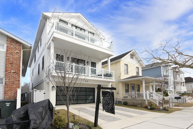 view of front of home featuring a garage, a balcony, and a porch