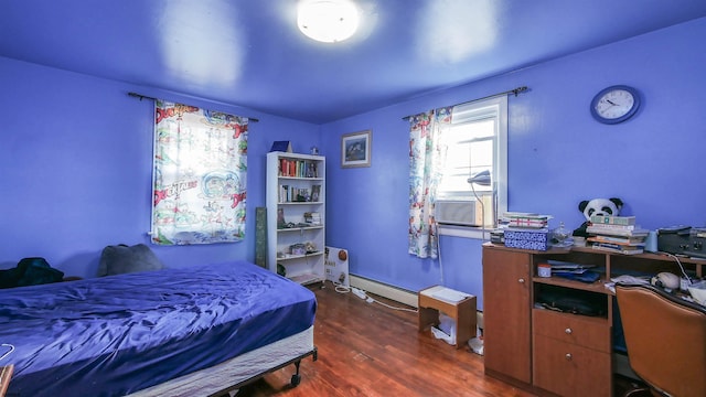 bedroom with cooling unit, dark hardwood / wood-style floors, and a baseboard heating unit