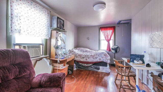 bedroom with wood-type flooring and cooling unit