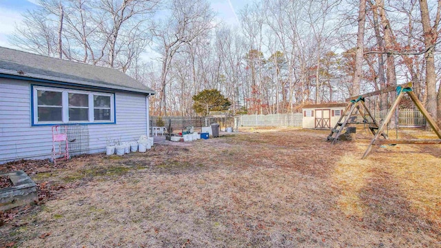 view of yard with a playground and a storage shed