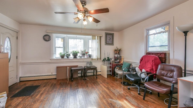 sitting room featuring ceiling fan, a baseboard heating unit, and dark hardwood / wood-style flooring