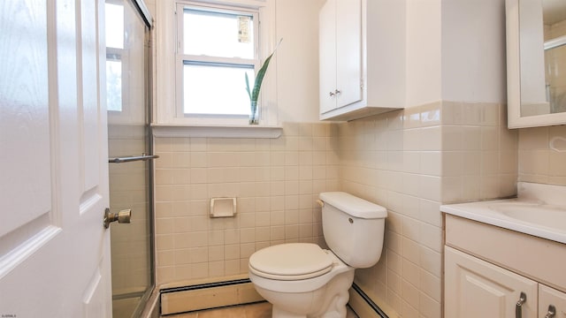 bathroom featuring baseboard heating, tile walls, vanity, a shower with shower door, and toilet