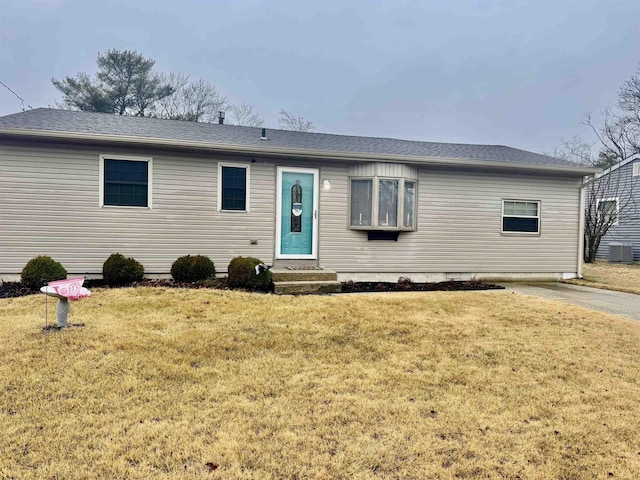 single story home featuring a front yard and central air condition unit