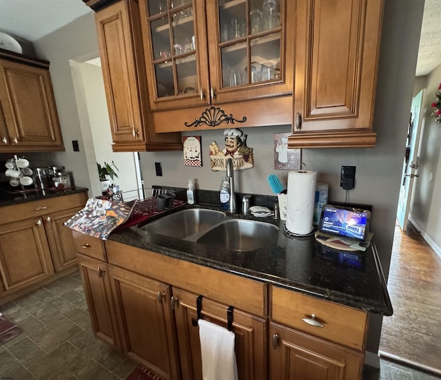 kitchen featuring dark stone counters and sink