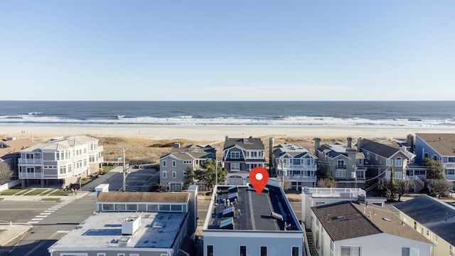 birds eye view of property featuring a water view and a view of the beach