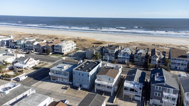 birds eye view of property featuring a beach view and a water view