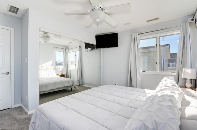 bedroom featuring carpet, a textured ceiling, and ceiling fan