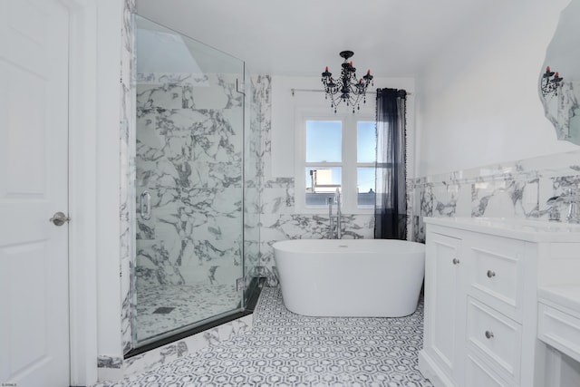 bathroom featuring independent shower and bath, vanity, and tile walls