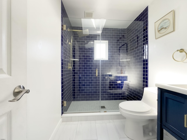 bathroom with vanity, toilet, and a shower with door