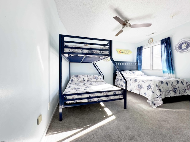 bedroom with ceiling fan, a textured ceiling, and carpet flooring