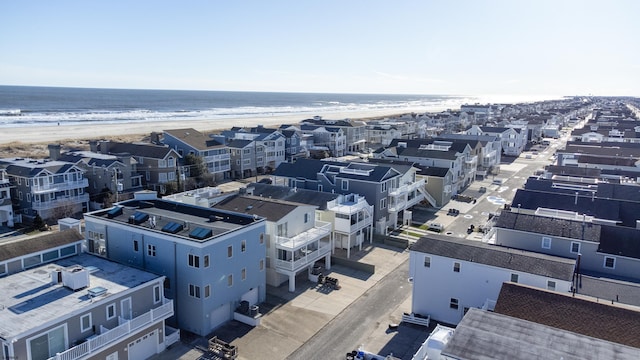 aerial view with a water view and a beach view