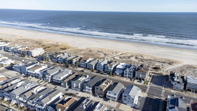 birds eye view of property featuring a view of the beach and a water view