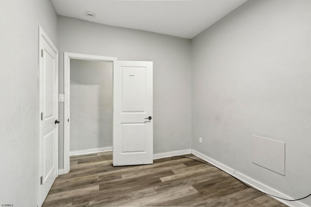 unfurnished bedroom featuring dark wood-type flooring