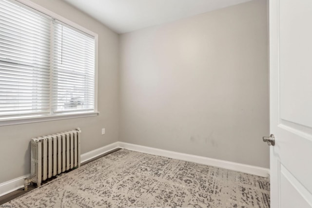 spare room featuring radiator