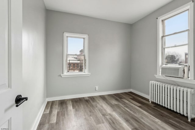 unfurnished room with wood-type flooring and radiator