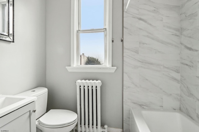 bathroom with vanity, toilet, and radiator