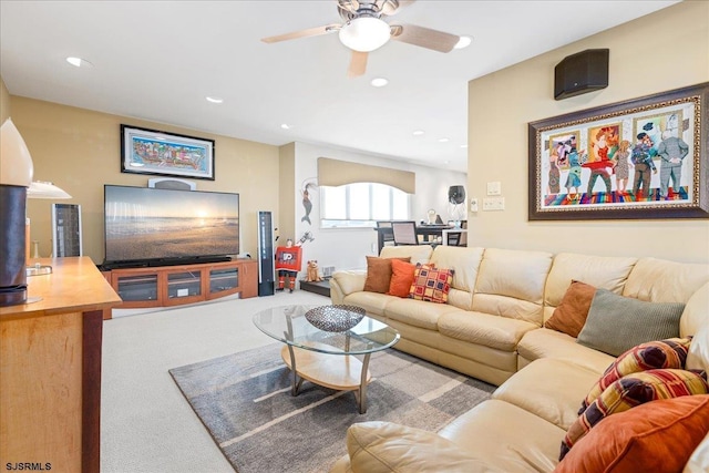 carpeted living room featuring ceiling fan